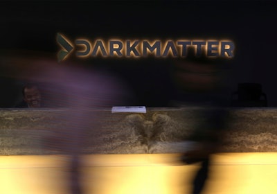 In this Tuesday, Jan. 30, 2018 photo, taken with a long exposure, employees walk into offices of the cybersecurity firm DarkMatter, in Abu Dhabi, United Arab Emirates. DarkMatter, a growing cybersecurity company that’s recruited Western intelligence analysts, is slowly stepping out of the shadows amid activist concerns about its power. CEO Faisal al-Bannai says DarkMatter takes part in no hacking but acknowledges the firm’s close business ties to the Emirati government, as well as hiring former CIA and National Security Agency analysts.