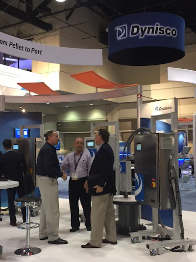 David Newell, Director of Sales at Dynisco, meets with attendees of the 2015 National Plastics Expo at Dynisco’s booth. Dynisco produces for global markets in the U.S., Europe and Asia.