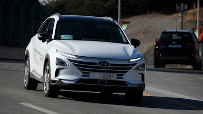 In this Monday, Feb. 12, 2018, photo, Hyundai's autonomous fuel cell electric vehicle Nexo is driven along a road near the Pyeongchang Olympic Stadium in Pyeongchang, South Korea. At Pyeongchang Winter Olympic Games, there are two futures of self-driving vehicles in two different Olympic venues by two different companies. In a reminder of a proxy war between automakers and tech companies, Hyundai and KT have negotiated over the exclusive right to use the buzzword.