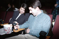 Moviegoers familiarize themselves with the joystick that will allow them to interact with the film ‘I’m Your Man’ during its premiere on Dec. 16, 1992.