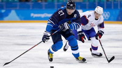 Petri Kontiola (27), of Finland, drives the puck against Johannes Johannesen (4), of Norway, during the first period of the preliminary round of the men's hockey game at the 2018 Winter Olympics in Gangneung, South Korea, Friday, Feb. 16, 2018.