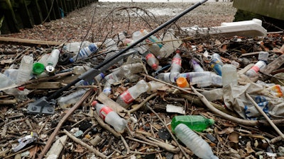 Plastic bottles and other plastics including a mop, lie washed up on the foreshore at the site of the ancient and no-longer used Queenhithe dock, a designated scheduled monument which dates back to at least the time of King Alfred the Great who lived from 849 to 899 AD, on the north bank of the River Thames in London, Monday, Feb. 5, 2018. Amid growing evidence of dire amounts of waste in the world’s oceans, conservation is becoming a selling point for firms trying to jump on the bandwagon of concern about the flood of plastic choking sea life.