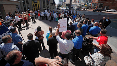 This Wednesday, May 1, 2013 file photo shows the AFL-CIO protesting proposed Right to Work Legislation on the South East corner of the Statehouse in Columbus, Ohio. A handful of states in the Midwest now surrounded by neighbors with so-called right-to-work laws are facing new efforts aimed at changing their labor laws. In Ohio, a pair of Republican lawmakers wants to put the issue before voters in two years. Missouri's new right-to-work law will go to a statewide referendum in November.