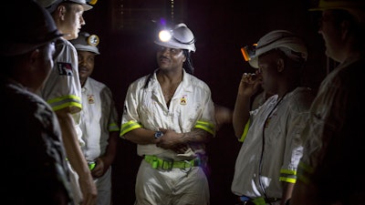 In this Feb. 1, 2018 photo, rescue workers prepare to rescue more than 900 miners from the Sibanye-Stillwater's Beatrix mine near Welkom, South Africa. The miners were brought to the surface Friday Feb. 2 2018 after a power failure, caused by a severe storm Wednesday had prevented lifts from bringing the night shift to the surface.