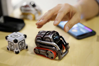 In this Jan. 10, 2018, file photo, Anki Cozmo coding robot is on display at CES International in Las Vegas. Cozmo, which debuted in 2016, now comes with an app called Code Lab that allows kids to drag and drop blocks of code that control its movements and animations. They can even access facial and object recognition functions enabled by Cozmo’s front-facing camera.