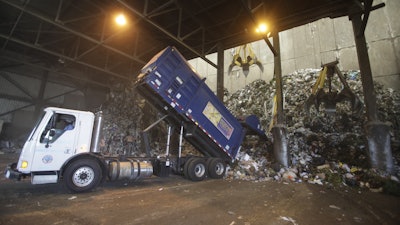 A trash truck discharges solid waste at the South East Reserve Recovery Facility’s refuse storage pit in Long Beach, California, August 24, 2010.