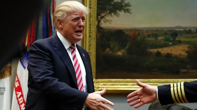 President Donald Trump shakes hands with Immediate Past President of the National Sheriffs' Association, St. Charles Parish, La., Sheriff Greg Champagne, as he arrives for a roundtable discussion with members the National Sheriffs' Association and others in the Roosevelt Room of the White House in Washington, Tuesday, Feb. 13, 2018.