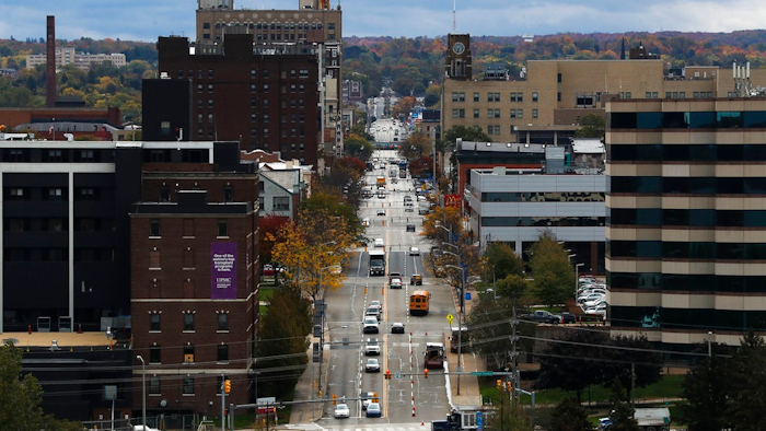 In this Oct. 24, 2017, photo, vehicles travel along State Street, the main thoroughfare through town, as seen from the Bicentennial Tower in Erie, Pa. Since 2008, Erie has suffered a hidden and potentially more devastating exodus: The loss of well-paid white-collar jobs. City leaders in Erie say it needs to retain those white-collar workers, more than it needs a return to a blue-collar past where the factories covered the east side of town in brown soot and Lake Erie was reserved for shipping instead of swimming and tourism.