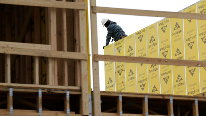 In this Monday, Feb. 26, 2018, photo, work continues on a new development in Fair Lawn, N.J. On Friday, March 9, the Labor Department reported that U.S. employers added 313,000 jobs in February, the most in any month since July 2016, and drawing hundreds of thousands of people into the job market.