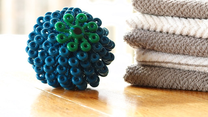 This Dec. 14, 2017 photo provided by Cora Ball shows the Cora Ball, a product developed by a nonprofit group called Rozalia Project that seeks to cut down on small threads that enter waterways when people do laundry. The group says the ball could cut down on this kind of pollution by more than 25 percent.