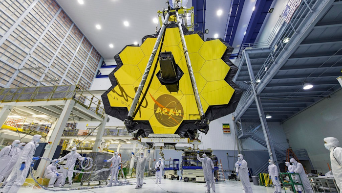 In this April 13, 2017 photo provided by NASA, technicians lift the mirror of the James Webb Space Telescope using a crane at the Goddard Space Flight Center in Greenbelt, Md. The telescope’s 18-segmented gold mirror is specially designed to capture infrared light from the first galaxies that formed in the early universe. On Tuesday, March 27, 2018, NASA announced it has delayed the launch of the next-generation space telescope until 2020.