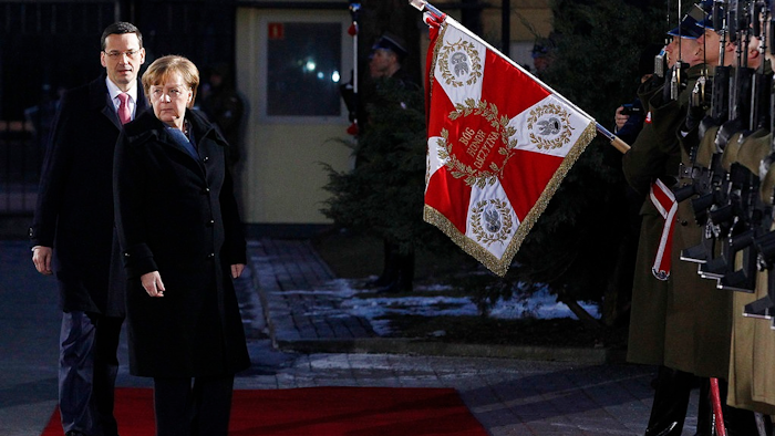 Poland's Prime Minister Mateusz Morawiecki,left, greets German Chancellor Angela Merkel before talks on European Union future and security and on bilateral ties at his office in Warsaw, Poland, Monday, March 19, 2018. Merkel was sworn in for her fourth term last week.