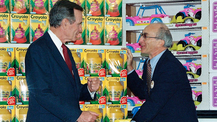 In this Jan. 7, 1992, file photo, President George H. Bush, left, listens to Toys R Us Chairman Charles Lazarus, right, as he visits the toy chain's second store to open in Japan. Lazarus, the World War II veteran who founded Toy R Us, has died at age 94. Toy R Us confirmed Lazarus’ death in a statement Thursday, March 22, 2018.
