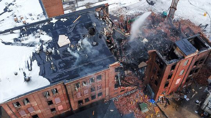 Firefighters work the scene of a fire that started Wednesday in York, Pa., Thursday, March 22, 2018. York officials said part of the four-story building fell on firefighters as they were looking for hot spots and investigating the cause of the fire that broke out Wednesday at the Weaver Organ and Piano factory.