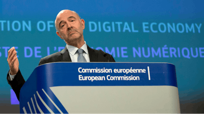 European Commissioner for Economic and Financial Affairs Pierre Moscovici speaks during a media conference at EU headquarters in Brussels, Wednesday, March 21, 2018.