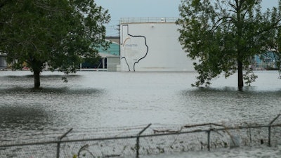 In this Aug. 30, 2017 photo, the Arkema chemical plant is flooded from Hurricane Harvey in Crosby, Texas, northeast of Houston. Nearby residents complain of a 'bitter taste' about the sparse information authorities provided when chemicals at the plant caught fire. They say the company failed to provide sufficient warning beforehand while environmental officials misled them with assurances that the air and water were safe. Critics say testing by authorities and contractors was inadequate to determine whether public health was threatened.