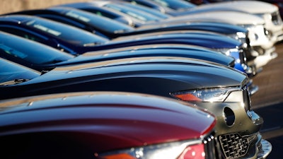 In this Sunday, Jan. 7, 2018, photograph, a long line of unsold 2017 and 2018 Maserati Levantes sits on a dealer's lot in Highlands Ranch, Colo. Industry analysts expect February 2018 sales to tail off from a year ago as automakers ease up on cash discounts and other incentives that hit record highs last year. Most automakers report sales figures Thursday, March 1.