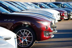 In this Sunday, Jan. 7, 2018, photograph, sun glints off the headlight housing of an unsold 2018 Maserati Levante in a long line of the high-end sports utility vehicles sitting on a dealer's lot in Highlands Ranch, Colo. On Wednesday, March 14, 2018, the Commerce Department releases U.S. retail sales data for February.
