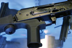 In this file photo, a device called a 'bump stock' is attached to a semi-automatic rifle at the Gun Vault store and shooting range in South Jordan, Utah.