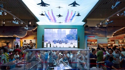In this Aug. 1, 2017, file photo, visitors look at a scale model of a Chinese aircraft carrier during an exhibition to mark the 90th anniversary of the founding of the People's Liberation Army at the military museum in Beijing. China's defense budget will rise 8 percent to 1.1 trillion yuan ($173 billion) this year as the country is preparing to launch its second aircraft carrier, integrating stealth fighters into its air force and fielding an array of advanced missiles able to attack air and sea targets at vast distances, according to a report released Monday, March 5, 2018.