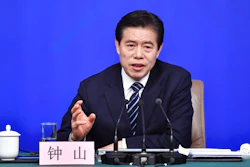 In this photo released by China's Xinhua News Agency, Chinese Minister of Commerce Zhong Shan speaks at a press conference in Beijing, Sunday, March 11, 2018. China says it will not initiate a 'disastrous' trade war with the United States, but is vowing to defend its national interests in the face of growing American protectionism.