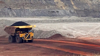 In this March 28, 2017 file photo, a dump truck hauls coal at Contura Energy's Eagle Butte Mine near Gillette, Wyo. A judge has ruled U.S. government officials engaged in regional-level planning must consider allowing less coal to be mined as a way to fight climate change. Friday, March 23, 2018 ruling by U.S. District Judge Brian Morris in Great Falls, Montana, applies to the country’s top coal-producing region, the Powder River Basin of Wyoming and Montana.