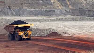 In this March 28, 2017 file photo, a dump truck hauls coal at Contura Energy's Eagle Butte Mine near Gillette, Wyo. A judge has ruled U.S. government officials engaged in regional-level planning must consider allowing less coal to be mined as a way to fight climate change. Friday, March 23, 2018 ruling by U.S. District Judge Brian Morris in Great Falls, Montana, applies to the country’s top coal-producing region, the Powder River Basin of Wyoming and Montana.