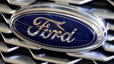 This Feb. 15, 2018, file photo shows a Ford logo on the grill of a 2018 Ford Explorer on display at the Pittsburgh Auto Show. Ford, with a sagging U.S. market share and one of the oldest vehicle lineups in the industry, is promising to revamp three-quarters of its models in the next two years. The move was detailed at a presentation on Thursday, March 15, at Ford's product development center in Dearborn, Mich.