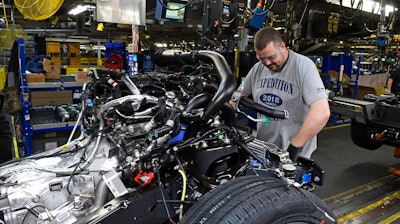 In this Oct. 27, 2017, file photo, workers assemble Ford trucks at the Ford Kentucky Truck Plant in Louisville, Ky. On Friday, March 16, 2018, the Federal Reserve reports on U.S. industrial production for February.