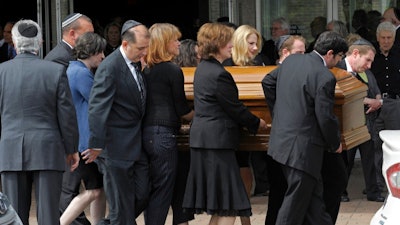 In this May 18, 2015, file photo, pallbearers carry the casket of Rachel Jacobs, a 39-year-old educational software executive who was among eight passengers killed when an Amtrak train from Washington to New York derailed in Philadelphia on May 12, to a hearse after her funeral service in Southfield, Mich. Gilda Jacobs, Rachel's mother, told a U.S. Senate committee Thursday, March 1, 2018, she is seething over the prospect of more delays in installing speed controls, known as positive train control or PTC, that could've prevented the wreck and dozens of others.