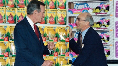 In this Jan. 7, 1992, file photo, President George H. Bush, left, listens to Toys R Us Chairman Charles Lazarus, right, as he visits the toy chain's second store to open in Japan. Lazarus, the World War II veteran who founded Toy R Us, has died at age 94. Toy R Us confirmed Lazarus’ death in a statement Thursday, March 22, 2018.