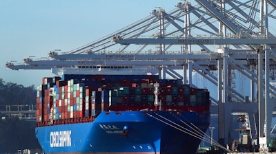 In this Jan. 30, 2018, file photo, a container ship waits to be unloaded at the Port of Oakland in Oakland, Calif. The Commerce Department reports on the U.S. trade gap for January, on Wednesday, March 7.