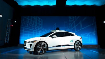 The Jaguar I-Pace vehicle is introduced Tuesday, March 27, 2018, in New York. Self-driving car pioneer Waymo will buy up to 20,000 of the electric vehicles from Jaguar Land Rover to help realize its vision for a robotic ride-hailing service. The commitment announced Tuesday marks another step in Waymo's evolution from a secret project started in Google nine years ago to a spin-off that's gearing up for an audacious attempt to reshape the transportation business.