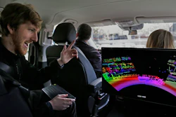 In this April 10, 2017, file photo, Luminar CEO Austin Russell gestures while looking at a 3D lidar map on a demonstration drive in San Francisco. Smaller versions of those spinning 360-degree mechanical laser sensors that sit atop self-driving cars are coming to mainstream vehicles. The lasers, called Lidar for Light Detection and Ranging, can see far-off objects in the dark, in bad weather, and in great detail.