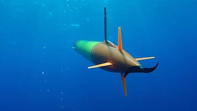 A long-range autonomous underwater vehicle carrying an environmental sample processor cruises beneath the surface during field trials in Hawaii.