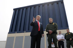 President Donald Trump speaks during a tours as he reviews border wall prototypes, Tuesday, March 13, 2018, in San Diego, as Rodney Scott, the Border Patrol's San Diego sector chief, listens.
