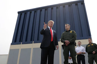 President Donald Trump speaks during a tours as he reviews border wall prototypes, Tuesday, March 13, 2018, in San Diego, as Rodney Scott, the Border Patrol's San Diego sector chief, listens.