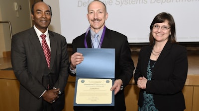 Mary Miller, right, performing the duties of assistant secretary of defense for research and engineering, and Dr. Jagadeesh Pamulapati, left, director, laboratories office, office of the assistant secretary of defense for research and engineering, present the Department of Defense STEM Advocate of the Quarter Award to Dr. John DiCecco from the Naval Undersea Warfare Center Division Newport, during the 2018 Engineers Week celebration held at the Pentagon Library and Conference Center.