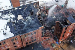 Firefighters work the scene of a fire that started Wednesday in York, Pa., Thursday, March 22, 2018. York officials said part of the four-story building fell on firefighters as they were looking for hot spots and investigating the cause of the fire that broke out Wednesday at the Weaver Organ and Piano factory.