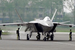 In this April 17, 2011 file photo, Chinese ground crew members inspect a J-20 stealth fighter in Chengdu, in southwest China's Sichuan province. China's defense budget will rise 8 percent to 1.1 trillion yuan ($173 billion) this year as the country is preparing to launch its second aircraft carrier, integrating stealth fighters into its air force and fielding an array of advanced missiles able to attack air and sea targets at vast distances, according to a report released Monday, March 5, 2018.