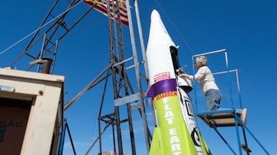 In this March 6, 2018, file photo, 'Mad' Mike Hughes begins work on repairing a steam leak after he scrubbed his launch attempt of his steam-powered rocket near Amboy, Calif. The self-taught rocket scientist who believes the Earth is flat propelled himself about 1,000 feet into the air before a hard-landing in the Mojave Desert that left him injured Saturday, March 24, 2018. Hughes tells The Associated Press that he injured his back but is otherwise fine after Saturday's launch near Amboy, Calif.