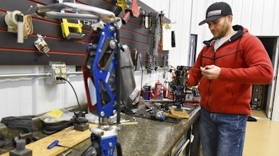 In this Dec. 22, 2017 photo, Mike Schultz works on a performance prosthetic for an athlete in his shop in St. Cloud, MN.