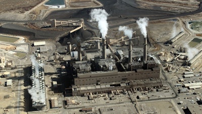 This file photo taken Nov. 9, 2009 image shows the coal-fired San Juan Generating Station near Farmington, N.M. One of the units at the San Juan Generating Station that serves customers in the southwestern United States has been taken offline as officials investigate a structural failure in one of its coal silos. Public Service Co. of New Mexico confirmed Tuesday, March 20, 2018, that the failure over the weekend at the generating station resulted in a fire and some damage that was limited to an area around the silo.