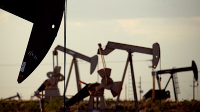 In this April 24, 2015 file photo, pumpjacks work in a field near Lovington, N.M. The boom in US oil production is expected to satisfy most of the world’s growing appetite for oil through 2023, according to a new forecast by a global energy group. The International Energy Agency worries that that investment in oil exploration and production is too low. The result could be the thinnest margin of oil-production capacity over demand in more than a decade.