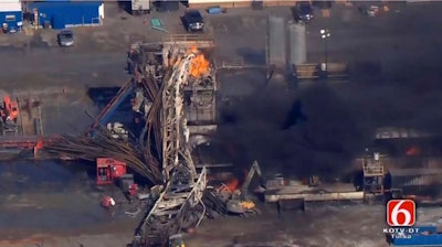 In this photo provided from a frame grab from Tulsa's KOTV/NewsOn6.com, fires burn at an eastern Oklahoma drilling rig near Quinton, Okla., Monday Jan. 22, 2018. Five people are missing after a fiery explosion ripped through a drilling rig, sending plumes of black smoke into the air and leaving a derrick crumpled on the ground, emergency officials said.