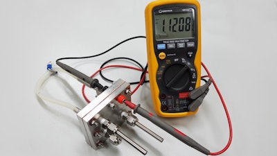 This is the RMIT-developed proton battery connected to a voltmeter. The working prototype has an energy per unit mass already comparable with commercially-available lithium ion batteries.