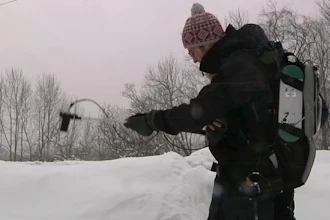 In this March 9, 2018 image taken from video, Patrick Alexander, a postdoctoral researcher at Columbia University's Lamont-Doherty Earth Observatory, uses a spectrometer to measure light radiating off a snowpack in Highmount, N.Y. Researchers are visiting New York’s Catskill Mountains this winter to study details about how snowflakes fall and how they evolve once they settle on the ground.