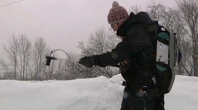 In this March 9, 2018 image taken from video, Patrick Alexander, a postdoctoral researcher at Columbia University's Lamont-Doherty Earth Observatory, uses a spectrometer to measure light radiating off a snowpack in Highmount, N.Y. Researchers are visiting New York’s Catskill Mountains this winter to study details about how snowflakes fall and how they evolve once they settle on the ground.