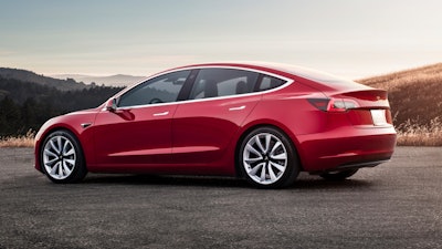 This undated photo provided by Tesla shows the Tesla Model 3, which delivers a sporty ride with a premium feel. The Model 3 is dramatically quicker and more engaging to drive than other popular EVs such as the BMW i3 and the Chevrolet Bolt.