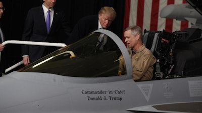 President Donald Trump participates in a tour of fighter aircraft at the Boeing Company, Wednesday, March 14, 2018, in St. Louis.